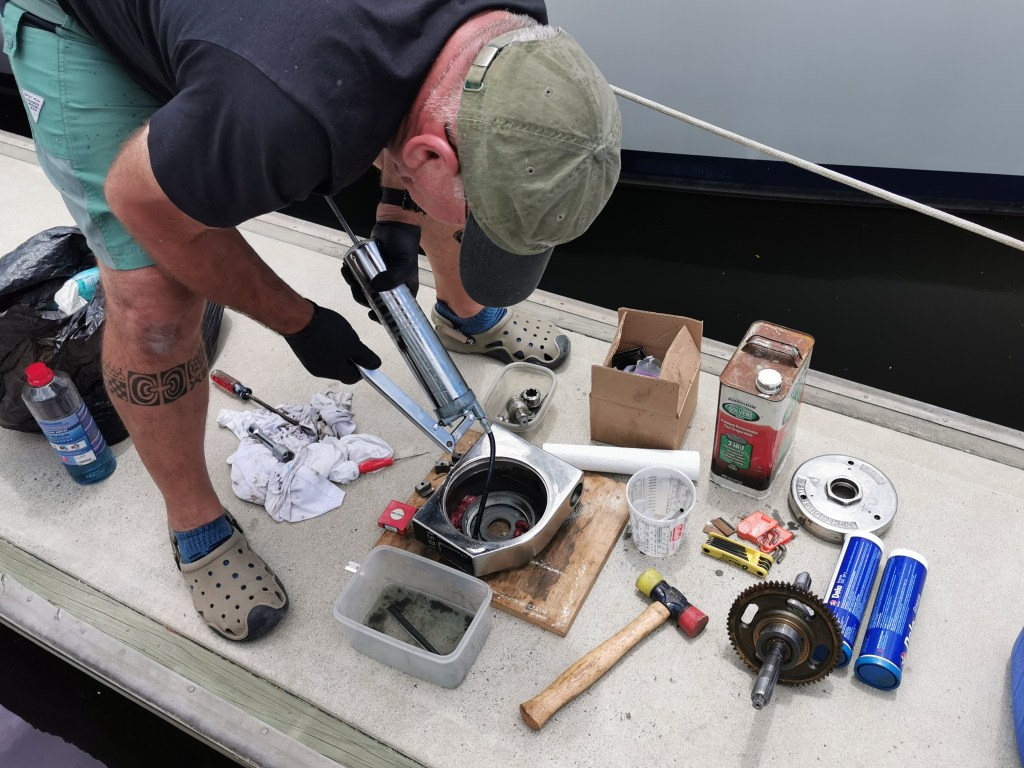 Dan injecting grease into windlass